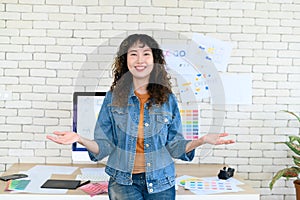 Portrait of cheerful female graphic designers in office. Creative people smiling at the camera during collaborative brainstorming