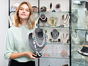 Female demonstrating pearl necklace