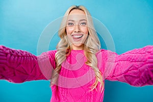 Portrait of cheerful flirty woman with wavy hairdo wear pink pullover doing selfie tongue lick lips isolated on blue