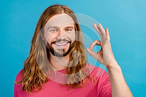 Portrait of cheerful friendly man beaming smile hand fingers demonstrate okey symbol isolated on blue color background