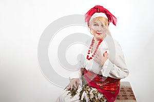 Portrait of a cheerful funny adult mature woman solokha. Female model in clothes of national ethnic Slavic style. A