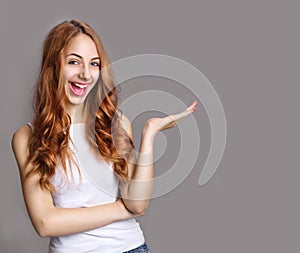 Portrait of a cheerful girl holding copyspace on the palm