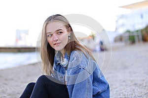 Portrait of cheerful girl who poses on camera and cute laughs si