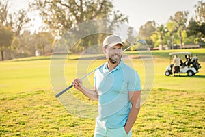 portrait of cheerful golfer in cap with golf club, sportsman