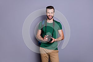 Portrait of cheerful guy ready travel abroad hold bag professional dlsr camera wear style stylish tendy clothes isolated photo