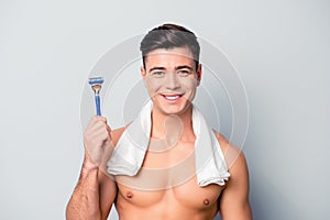 Portrait of cheerful handsome sporty smiling shaven guy wit photo