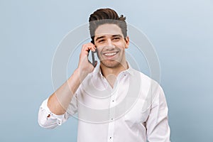 Full length portrait of a cheerful handsome young man