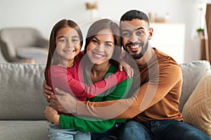 Portrait of cheerful happy Arab family smiling at home