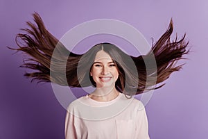 Portrait of cheerful happy beautiful girl wind blow face toothy smile on violet background