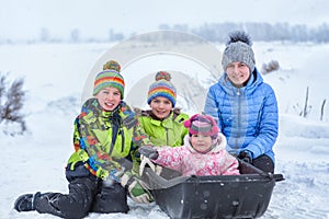 Portrait of cheerful happy boys and girls in winter clothes.