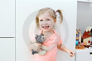 Portrait of cheerful happy cute little girl in the children`s ro