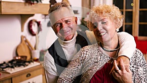 Portrait of a cheerful happy elderly couple smilling to camera on Christmas holidays.
