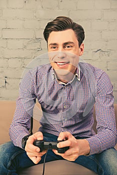 Portrait of cheerful happy man playing video games