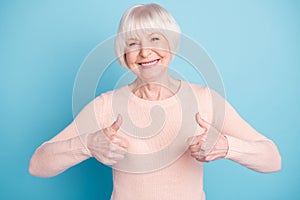 Portrait of cheerful lady showing thumb up smiling wearing paste jumper isolated over blue background