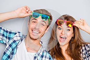 Portrait of cheerful laughing funny young lovers in glasses