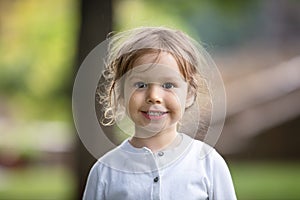 Portrait of cheerful little girl outdoors