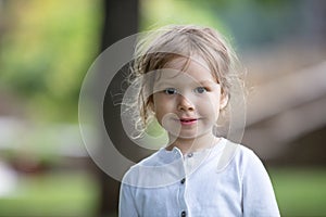 Portrait of cheerful little girl outdoors