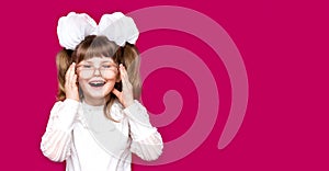 Portrait of cheerful little girl in very big glasses isolated on pink. Concept of eyesight or teaching