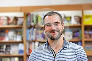 Portrait of cheerful man in a bookstore