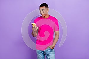 Portrait of cheerful man with fade haircut wear pink t-shirt telegram instagram facebook whatsapp isolated on purple