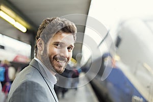 Portrait of cheerful man on platform station. Looking camera