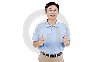 Portrait of cheerful man showing thumbs up while standing