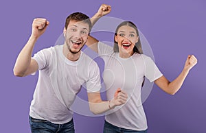 Portrait of cheerful people smiling and clenching fists