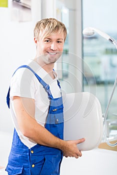 Portrait of a cheerful man working in a sanitary ware shop