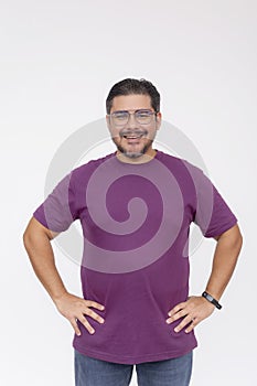 Portrait of a cheerful middle-aged man confidently smiling with hands on hips, isolated on a white backdrop