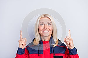 Portrait of cheerful person look interested direct fingers up empty space promo isolated on grey color background