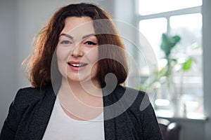 Portrait of a cheerful plus size model