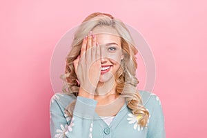 Portrait of cheerful positive girl toothy smile arm cover one eye isolated on pink color background