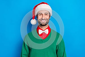 Portrait of cheerful positive young man beaming smile wear newyear hat isolated on blue color background