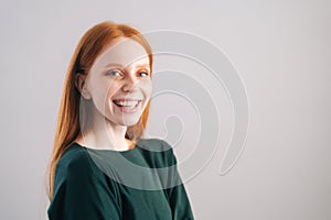 Portrait of cheerful redhead young woman model laughing looking at camera on white background.