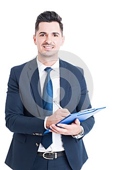 Portrait of cheerful salesman with clipboard taking notes