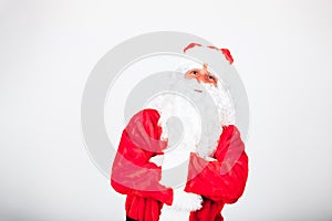 Portrait of a cheerful santa claus looking straight to the camera. christmas concept