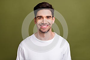 Portrait of cheerful satisfied young man toothy beaming smile good mood isolated on khaki color background