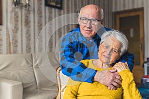 portrait of a cheerful senior Caucasian couple embracing in the living room medium closeup senior people love concept