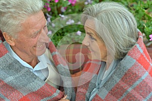 Portrait of cheerful senior couple at home on terrace