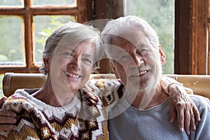 Portrait of cheerful senior couple looking on camera and embracing each other. Old age lifestyle people happiness concept with man