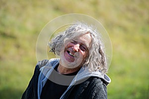 Portrait of a cheerful senior homeless man