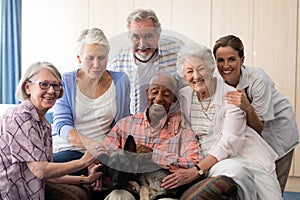 Portrait of cheerful senior people and practitioner with dog