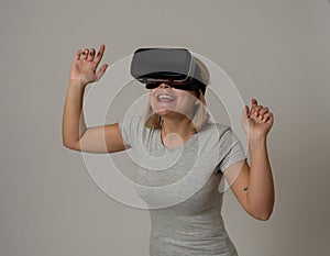 Portrait of cheerful and shocked young woman wearing Virtual Reality headset exploring 3D world