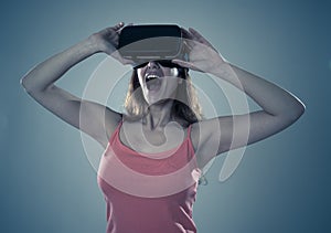 Portrait of cheerful and shocked young woman wearing Virtual Reality headset exploring 3D world