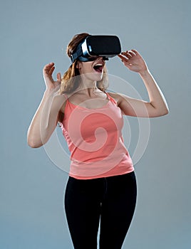 Portrait of cheerful and shocked young woman wearing Virtual Reality headset exploring 3D world