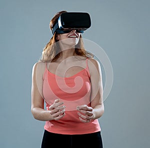 Portrait of cheerful and shocked young woman wearing Virtual Reality headset exploring 3D world