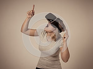 Portrait of cheerful and shocked young woman wearing Virtual Reality headset exploring 3D world