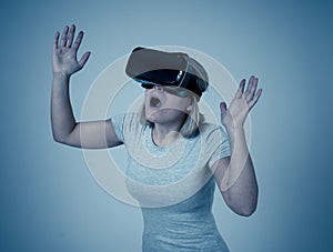 Portrait of cheerful and shocked young woman wearing Virtual Reality headset exploring 3D world