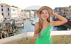 Portrait of a cheerful smiling tourist girl in straw hat in Venice, Italy