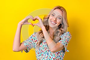 Portrait of cheerful stunning cute kind lady dressed stylish clothes two arms make heart symbol isolated on yellow color